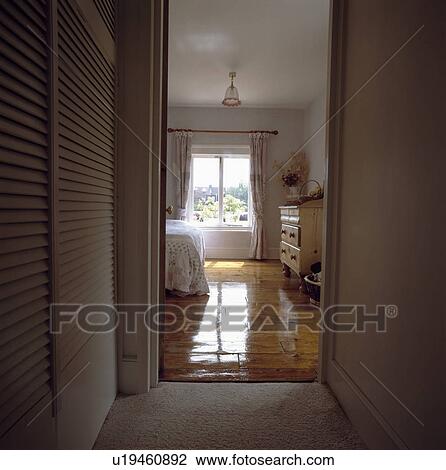 View through open door to shiny lacquered floorboards in traditional bedroom View Large Photo Image Stock Image - View through open door to shiny lacquered floorboards in traditional bedroom. Fotosearch