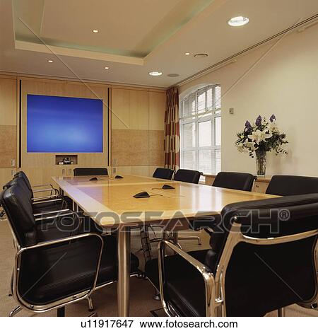 Well-lit modern designer decorated boardroom with built in monitor. View Large Photo Image Stock Photo - Well-lit modern designer decorated boardroom with built in monitor.. Fotosearch