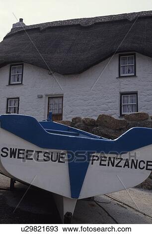 White and blue rowing boat in front of thatched white cottage in Cornwall View Large Photo Image Stock Image - White and blue rowing boat in front of thatched white cottage in Cornwall . Fotosearch