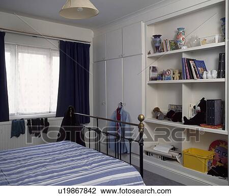 White bedroom with built in wardrobe and shelving unit View Large Photo Image Stock Image - White bedroom with built in wardrobe and shelving unit. Fotosearch