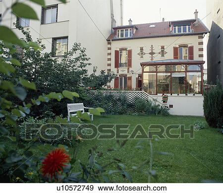 White bench on lawn in front of townhouse in France View Large Photo Image Stock Photo - White bench on lawn in front of townhouse in France. Fotosearch