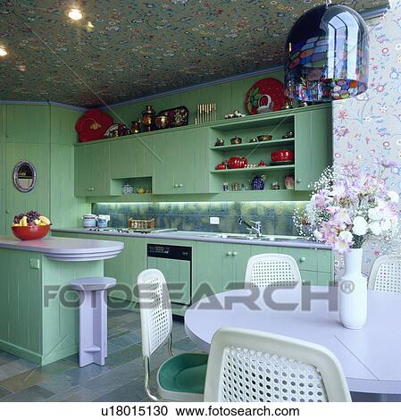 White chairs and lilac table in pastel green kitchen with floral patterned ceiling View Large Photo Image Stock Image - White chairs and lilac table in pastel green kitchen with floral patterned ceiling. Fotosearch