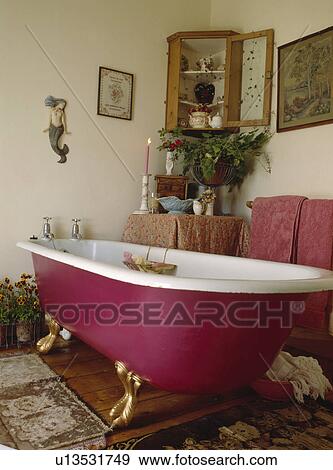 White clawfoot bath with pink underside in traditional bathroom View Large Photo Image Stock Photo - White clawfoot bath with pink underside in traditional bathroom. Fotosearch