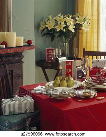 white crockery and Christmas presents on red tablecloth in pastel green diningroom View Large Photo Image Stock Photograph - white crockery and Christmas presents on red tablecloth in pastel green diningroom . Fotosearch