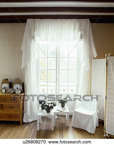 White loosecover on chair in front of French windows with white curtains View Large Photo Image Stock Image - White loosecover on chair in front of French windows with white curtains. Fotosearch