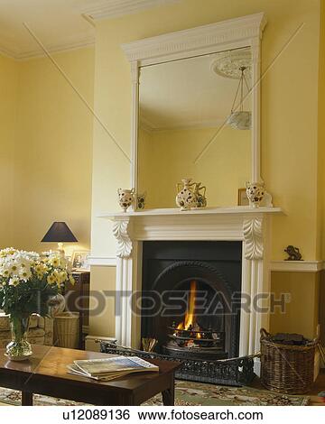 White mirror above white fireplace in pastel yellow livingroom View Large Photo Image Stock Photograph - White mirror above white fireplace in pastel yellow livingroom. Fotosearch