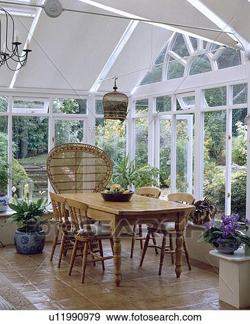 White painted wooden conservatory with pine table and chairs. View Large Photo Image Stock Photo - White painted wooden conservatory with pine table and chairs.. Fotosearch