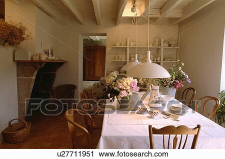 White pendant lights above table with white cloth in white country dining room with white beamed ceiling View Large Photo Image Stock Image - White pendant lights above table with white cloth in white country dining room with white beamed ceiling. Fotosearch