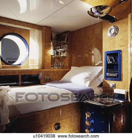 White pillow and linen on walnut wood fitted bed in compact hotel bedroom View Large Photo Image Stock Photo - White pillow and linen on walnut wood fitted bed in compact hotel bedroom. Fotosearch