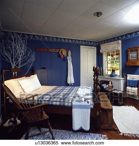 White quilt and blue+white checked blanket on bed in New England style blue bedroom with stencilled white border View Large Photo Image Stock Photography - White quilt and blue+white checked blanket on bed in New England style blue bedroom with stencilled white border. Fotosearch