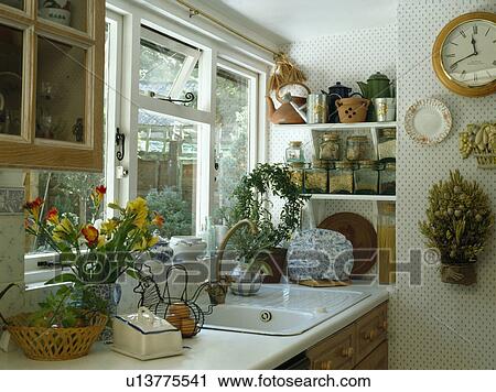 White sink below window in small kitchen with spotted wallpaper View Large Photo Image Stock Image - White sink below window in small kitchen with spotted wallpaper. Fotosearch
