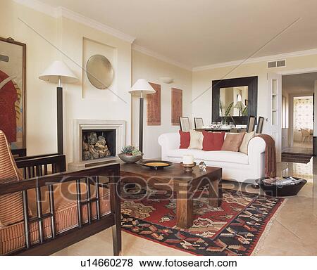 Stock Photo - White sofa and patterned rug in white living room. Fotosearch