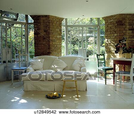 Stock Image - White sofa in modern white living room extension. Fotosearch