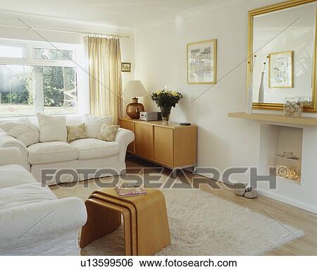 Stock Photograph - White sofas and modern nest-of-tables in white living room. Fotosearch