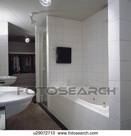 Stock Image - White tiled architectural bathroom with dressingroom. Fotosearch