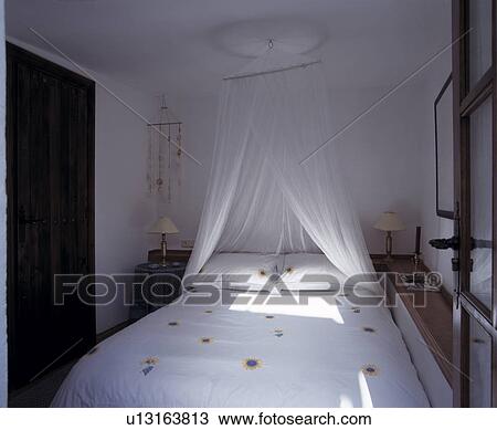 White voile mosquito net above bed with white pillows and duvet in white Mediterranean bedroom View Large Photo Image Stock Image - White voile mosquito net above bed with white pillows and duvet in white Mediterranean bedroom. Fotosearch
