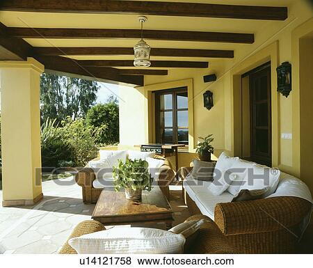 Stock Photo - Wicker sofas on veranda of villa in Southern Spain. Fotosearch