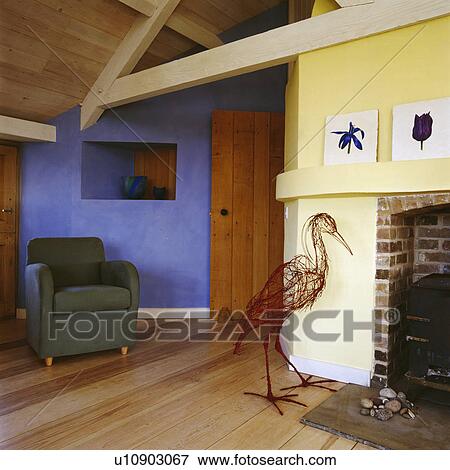 Stock Photo - Wicker stork in modern yellow cottage living room with blue wall. Fotosearch