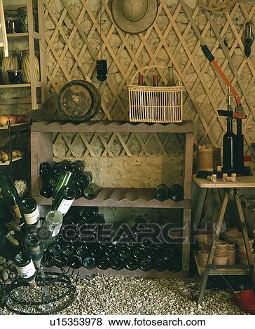 Wine bottles on wooden shelves in cellar View Large Photo Image Stock Photo - Wine bottles on wooden shelves in cellar. Fotosearch