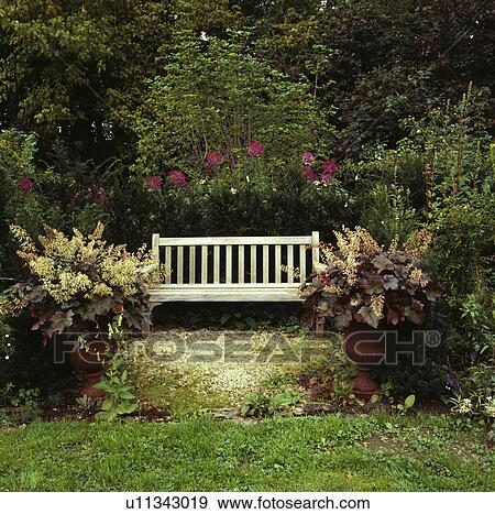 Wooden bench in country garden in summer View Large Photo Image Stock Photo - Wooden bench in country garden in summer. Fotosearch