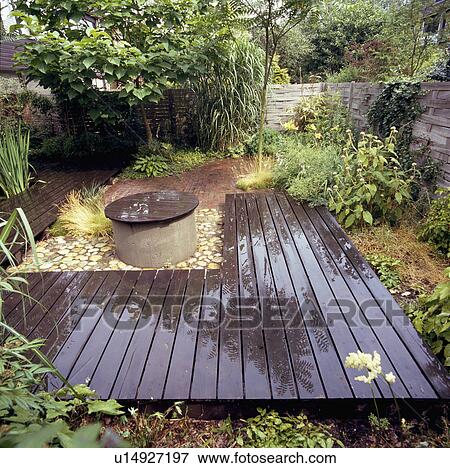 Wooden decking in overgrown country garden View Large Photo Image Stock Photo - Wooden decking in overgrown country garden. Fotosearch