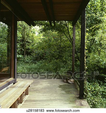 Wooden decking on veranda of small country house View Large Photo Image Stock Image - Wooden decking on veranda of small country house. Fotosearch