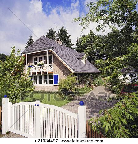 Wooden gates in fence in front of house in the country View Large Photo Image Stock Photo - Wooden gates in fence in front of house in the country. Fotosearch