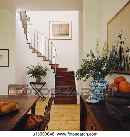 Wooden staircase and flooring in modern openplan dining room with traditional furniture View Large Photo Image Stock Photograph - Wooden staircase and flooring in modern openplan dining room with traditional furniture. Fotosearch