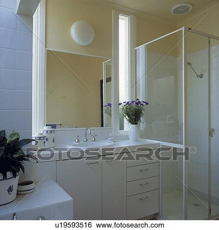 Yellow and white bathroom with shower cubicle, extractor fan and storage. View Large Photo Image Stock Photograph - Yellow and white bathroom with shower cubicle, extractor fan and storage.. Fotosearch