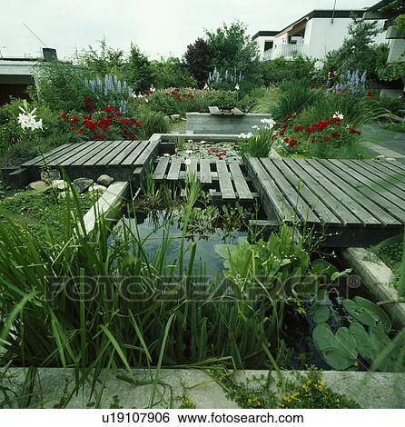 Stock Photograph - Angular pond in summer garden. Fotosearch