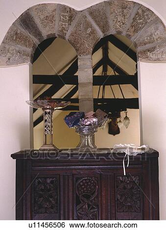 Antique carved chest below stone arched opening onto hall View Large Photo Image Stock Photograph - Antique carved chest below stone arched opening onto hall. Fotosearch
