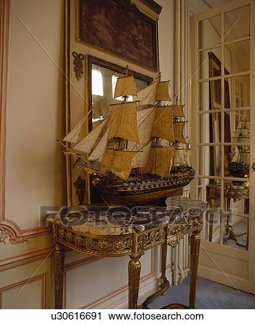 Antique model sailing ship on gilt and marble console table in traditional hall View Large Photo Image Stock Image - Antique model sailing ship on gilt and marble console table in traditional hall. Fotosearch
