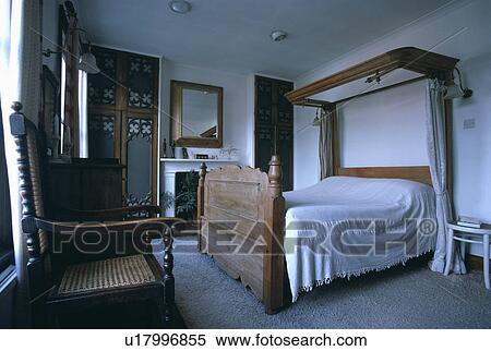 Antique pine half-tester bed with white bedcover in white country bedroom with grey carpet View Large Photo Image Stock Photography - Antique pine half-tester bed with white bedcover in white country bedroom with grey carpet. Fotosearch