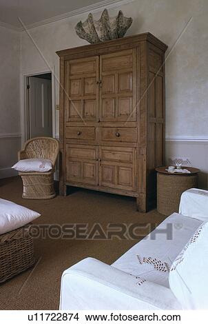 Antique pine linen press in traditional living room with white sofas View Large Photo Image Picture - Antique pine linen press in traditional living room with white sofas. Fotosearch