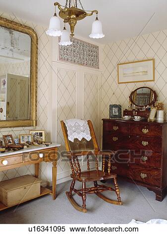 Antique rocking chair and mahogany chest of drawers in country bedroom with trellis wallpaper View Large Photo Image Stock Photography - Antique rocking chair and mahogany chest of drawers in country bedroom with trellis wallpaper. Fotosearch