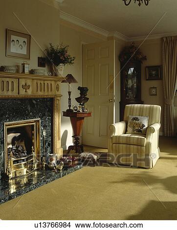Armchair beside fireplace in traditional living room View Large Photo Image Picture - Armchair beside fireplace in traditional living room. Fotosearch