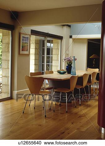 Arne Jacobsen style chairs and wooden table in modern dining room with wooden flooring View Large Photo Image Stock Image - Arne Jacobsen style chairs and wooden table in modern dining room with wooden flooring. Fotosearch