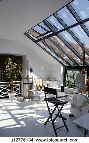 Picture - Artists studio with large glazed wall overlooking garden.. Fotosearch