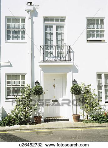Balcony above white front door of modern white house View Large Photo Image Stock Image - Balcony above white front door of modern white house. Fotosearch