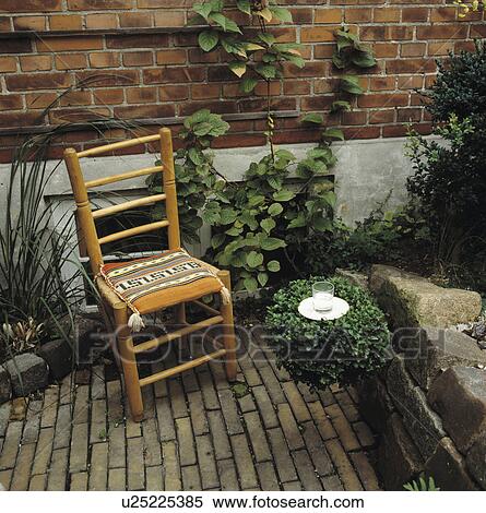 Bamboo chair on paving in walled garden View Large Photo Image Stock Photography - Bamboo chair on paving in walled garden. Fotosearch