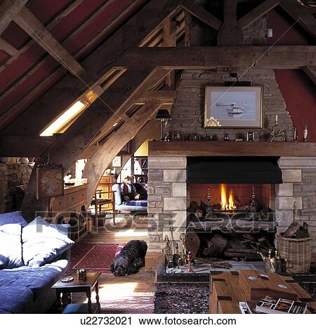Barn conversion living room with lighted fire in stone fireplace View Large Photo Image Stock Image - Barn conversion living room with lighted fire in stone fireplace. Fotosearch