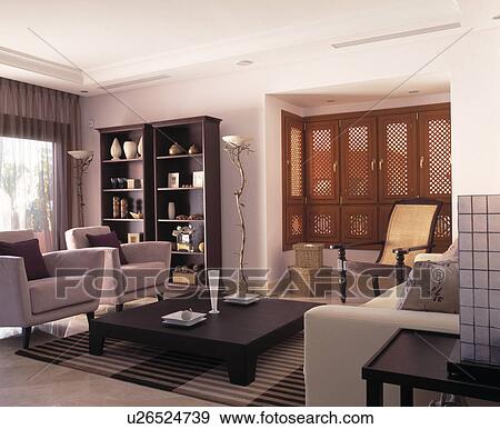Stock Photo - Beige sofa and armchairs in modern living room. Fotosearch