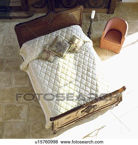 Stock Photo - Birdseye view of double bed with cream quilt in furniture showroom. &#13; &#10; &#13; &#10; &#13; &#10;. Fotosearch
