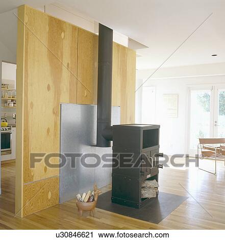 Stock Image - Black iron stove in modern openplan living room. Fotosearch