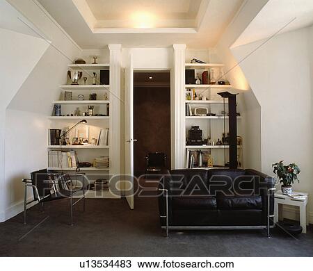 Black leather and chrome sofa in modern attic living room View Large Photo Image Stock Image - Black leather and chrome sofa in modern attic living room. Fotosearch