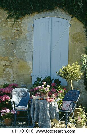 Blue chairs and blue cloth on table in country garden in summer View Large Photo Image Stock Photograph - Blue chairs and blue cloth on table in country garden in summer. Fotosearch