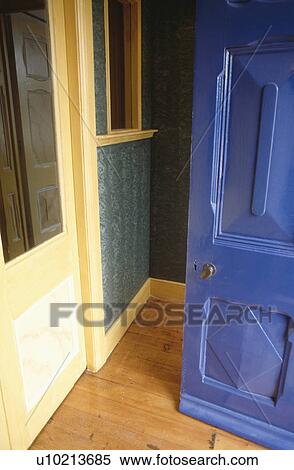 Stock Photography - Blue door open to small hall with wooden flooring. Fotosearch