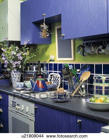Picture - Blue painted wooden kitchen units. Fotosearch