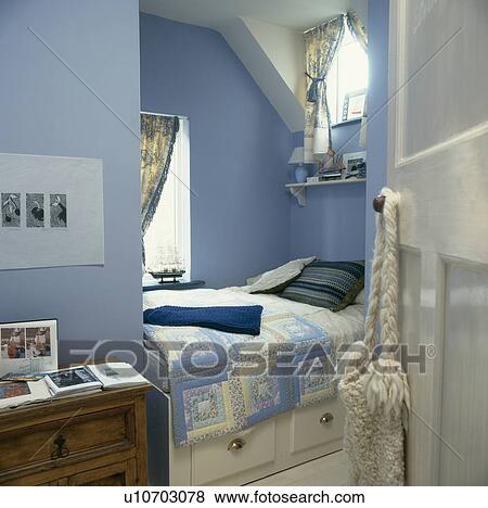 Blue patchwork quilt on built-in bed with storage drawers in small blue guest room View Large Photo Image Stock Photo - Blue patchwork quilt on built-in bed with storage drawers in small blue guest room. Fotosearch