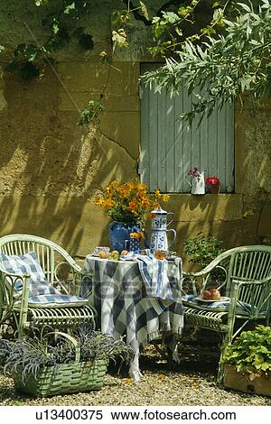 Blue+white cloth and pots on table in front of old stone wall in country garden in summer View Large Photo Image Stock Photography - Blue+white cloth and pots on table in front of old stone wall in country garden in summer. Fotosearch
